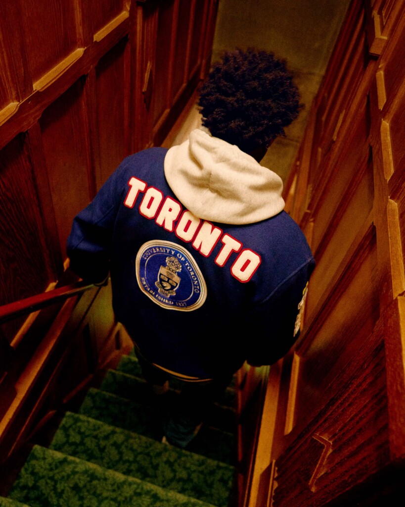 Musician Roy Woods modelling U of T OVO Varsity Jacket back view