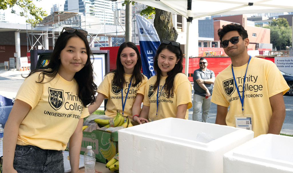 Four students posing during move-in day wearing Trinity College branded t-shirts